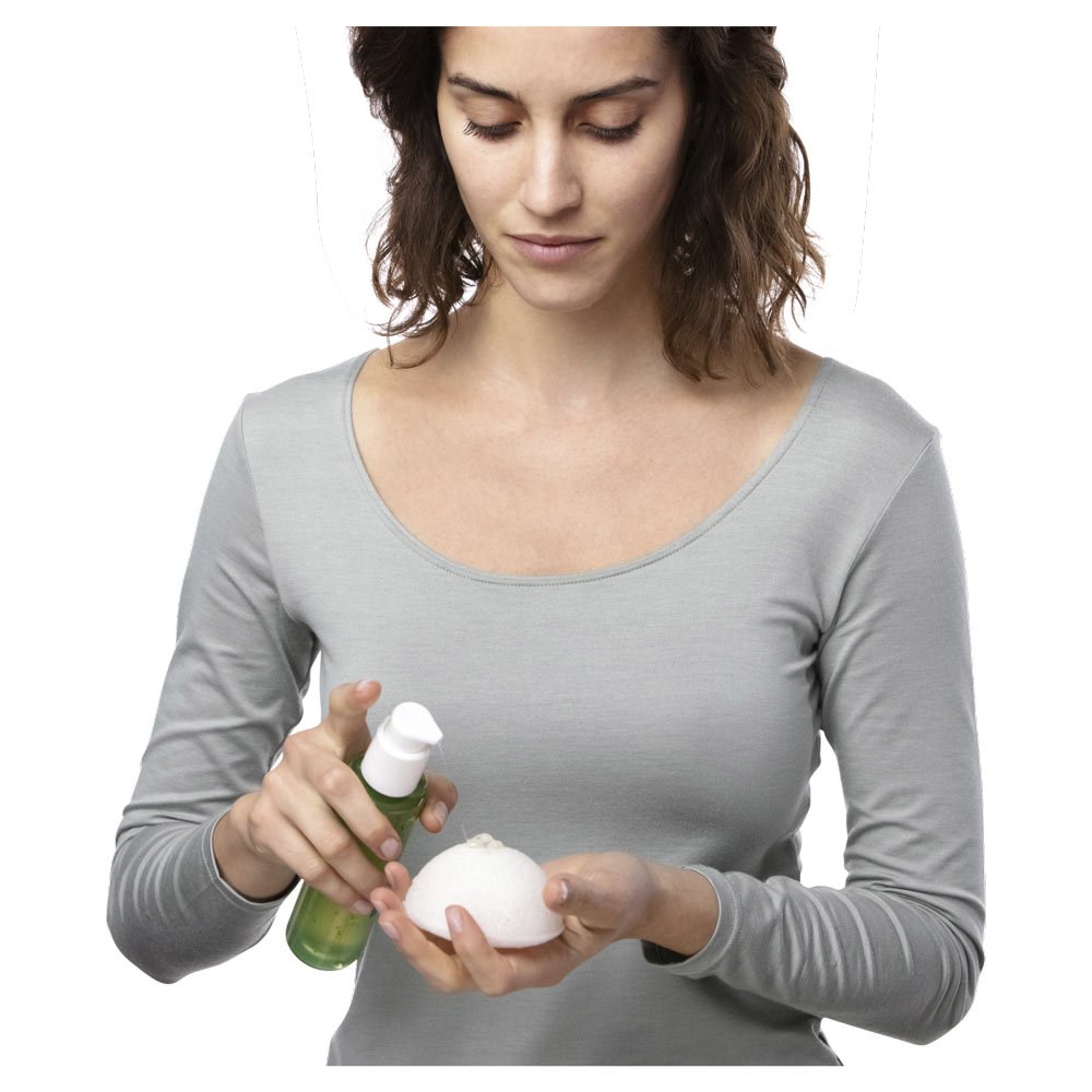 Garnier Organics Konjac Cleansing Sponge woman spraying cleanser onto sponge